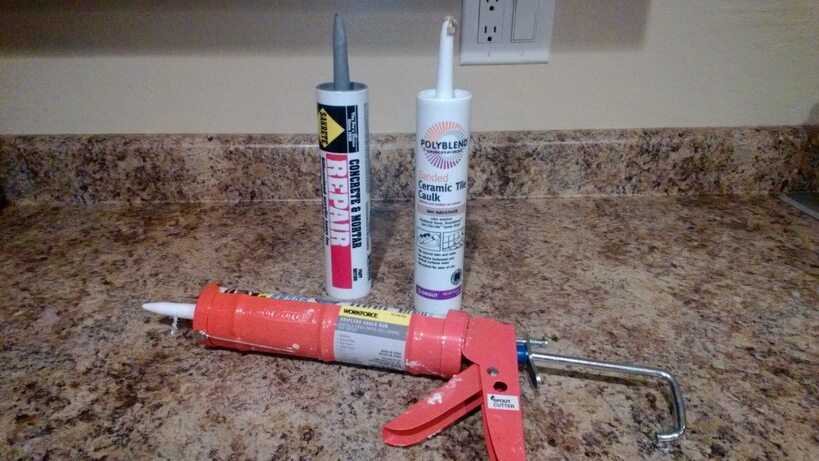 Caulking gun on a kitchen counter.